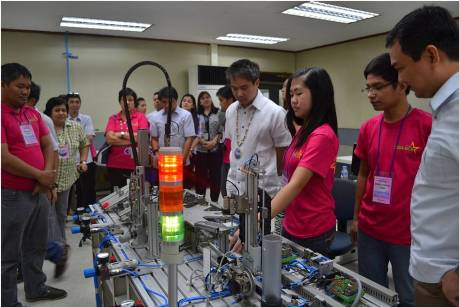 Secretary Joel Villanueva, TESDA director general, checks the work of young specialist doing a test piece on Mechatronics during the National Capital Region leg of the Regional Skills Competition.